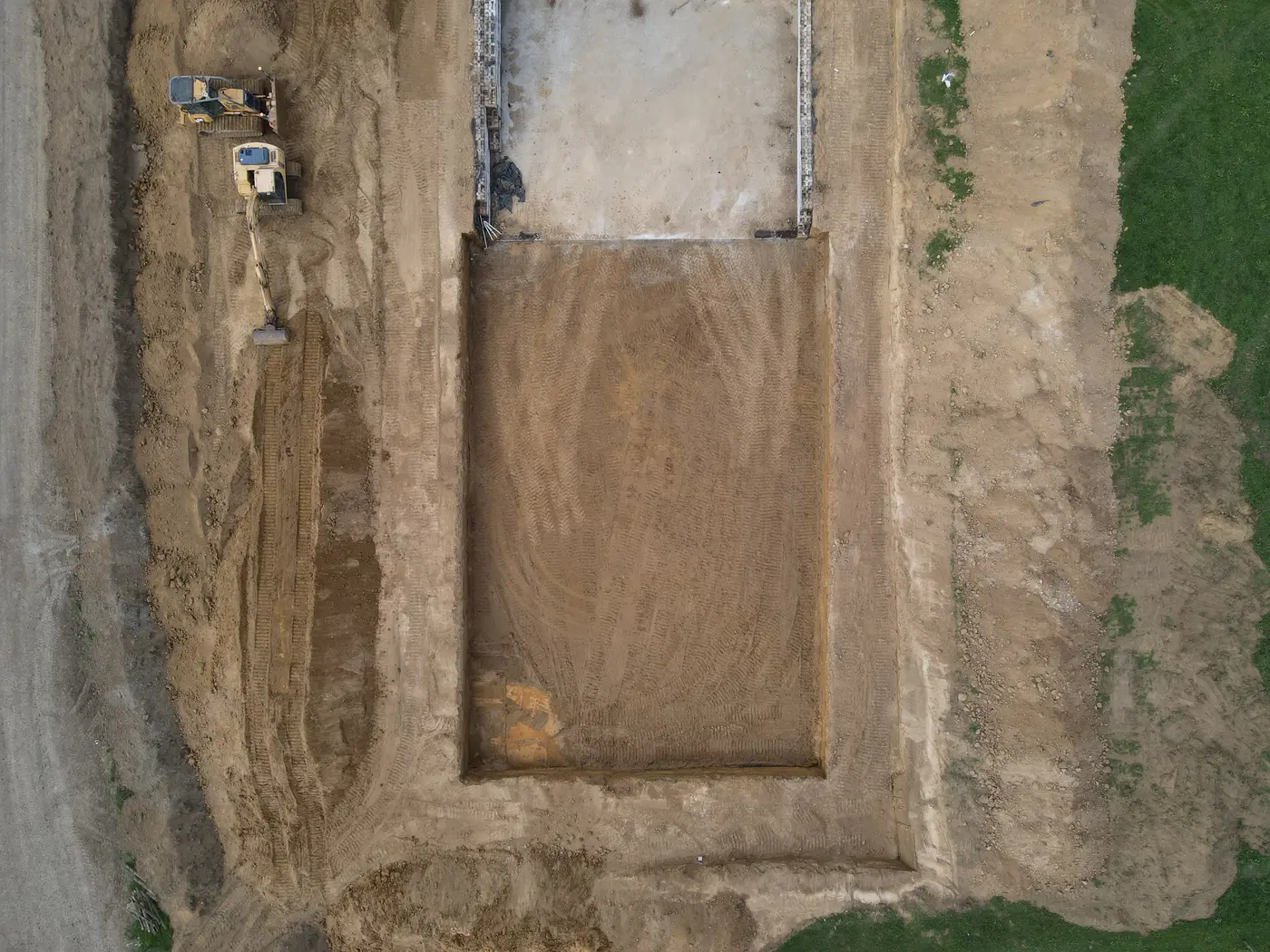 Top-down aerial of a large excavation cut to grade