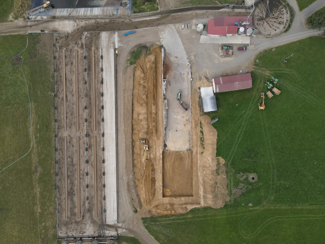 Aerial of a formed farm race and pad beside dairy sheds